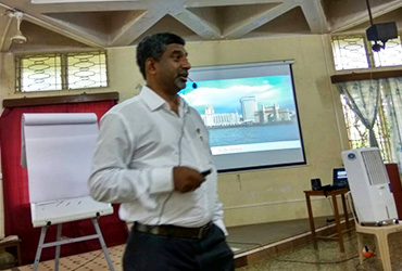 Participants engaging in relaxation and focus exercises in a Stress Management seminar